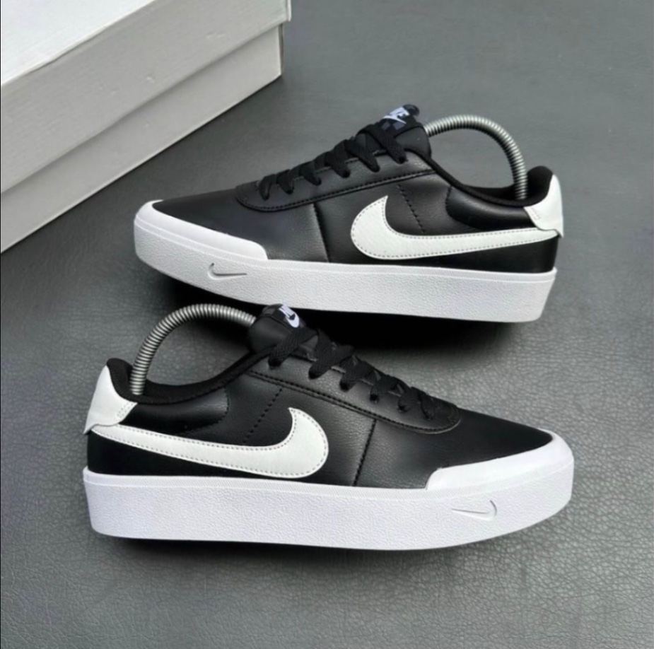 Nike Court Shot Men's black and white leather sneakers featuring a thick rubber midsole and debossed swoosh logo detail