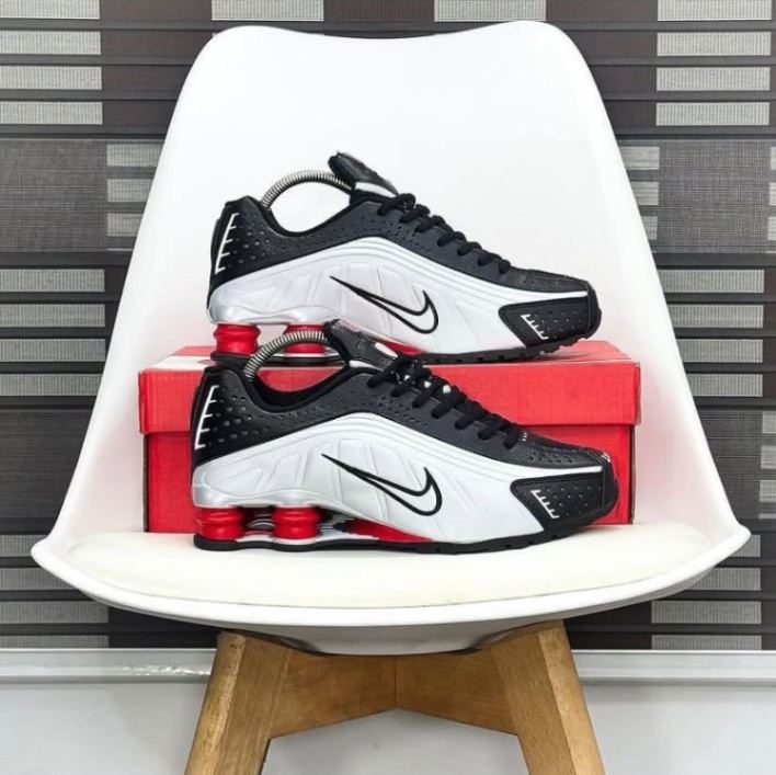 Original Nike Men's Shox R4 sneakers in a black and metallic silver colorway with red cushioning pillars