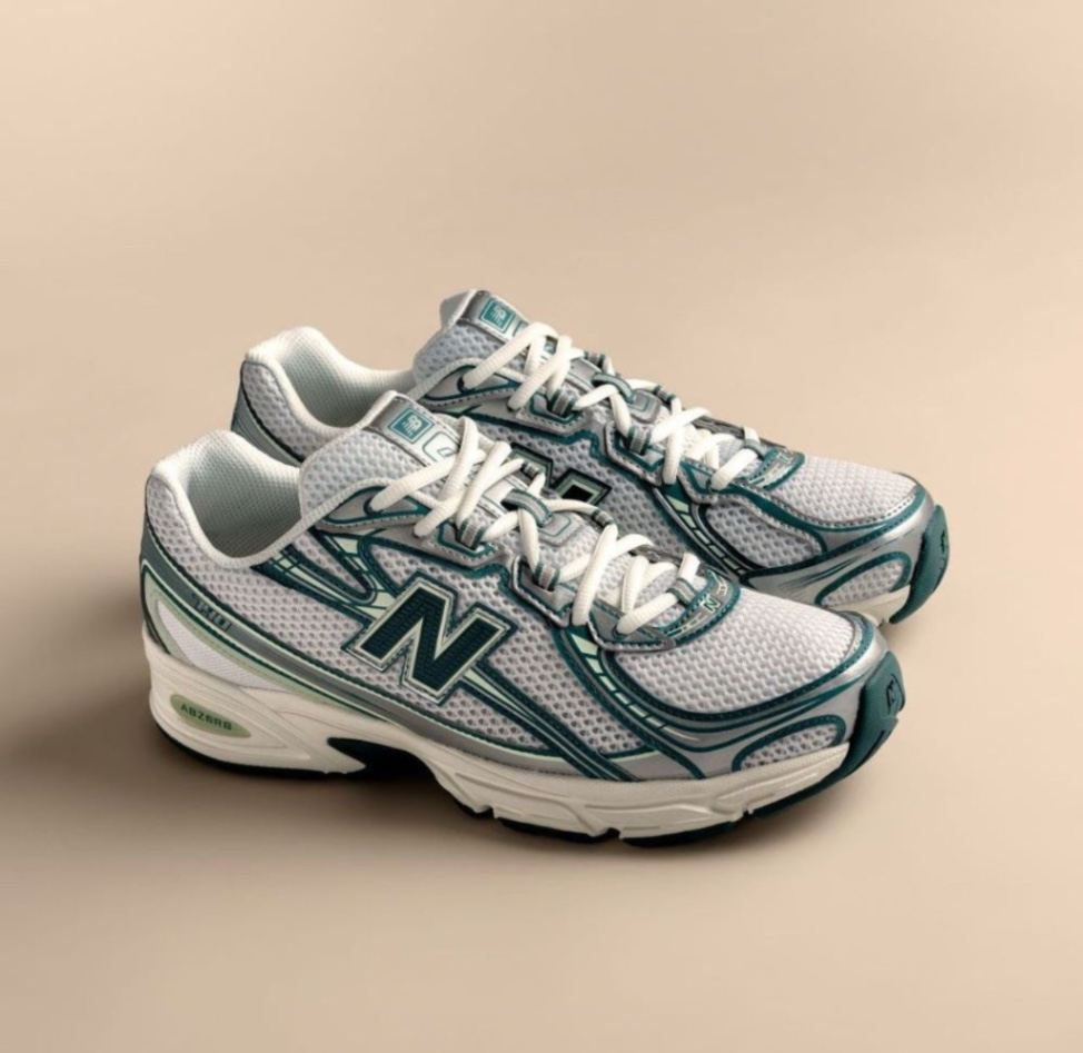 New Balance 740 sneakers in the white and marsh green colorway. 