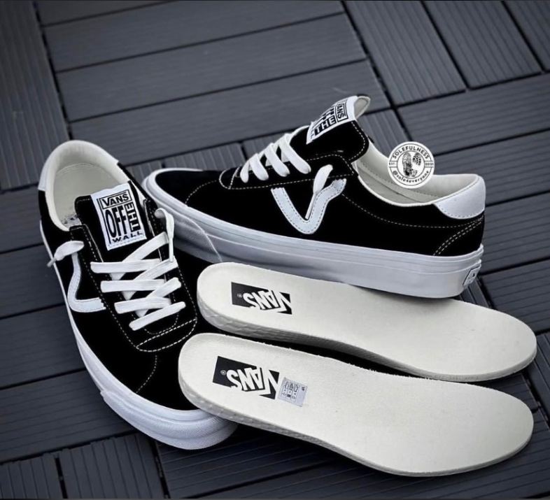 Black and white Vans Premium Sport 73 low-top sneakers featuring suede material and a unique "V" sidestripe